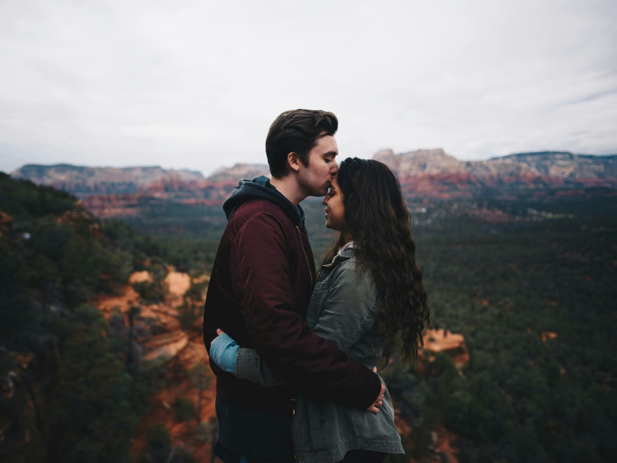 A couple sharing a quiet, tender moment on a canyon overlook