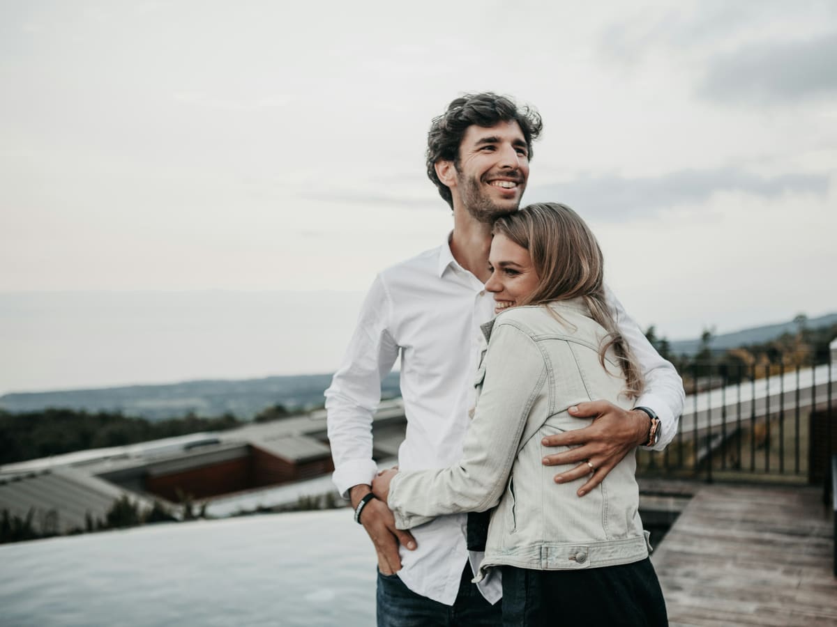 A couple embracing and smiling, reconnected after marriage counseling